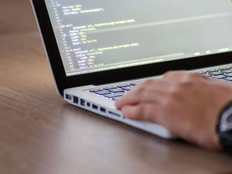 Website code open on a laptop