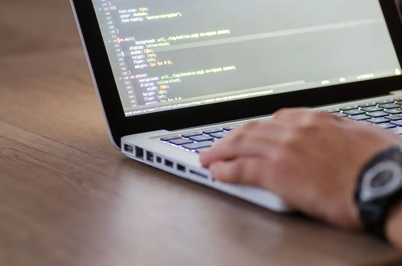 Website code open on a laptop