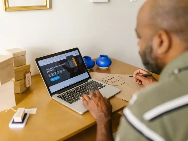 A business owner reviewing his website on a laptop