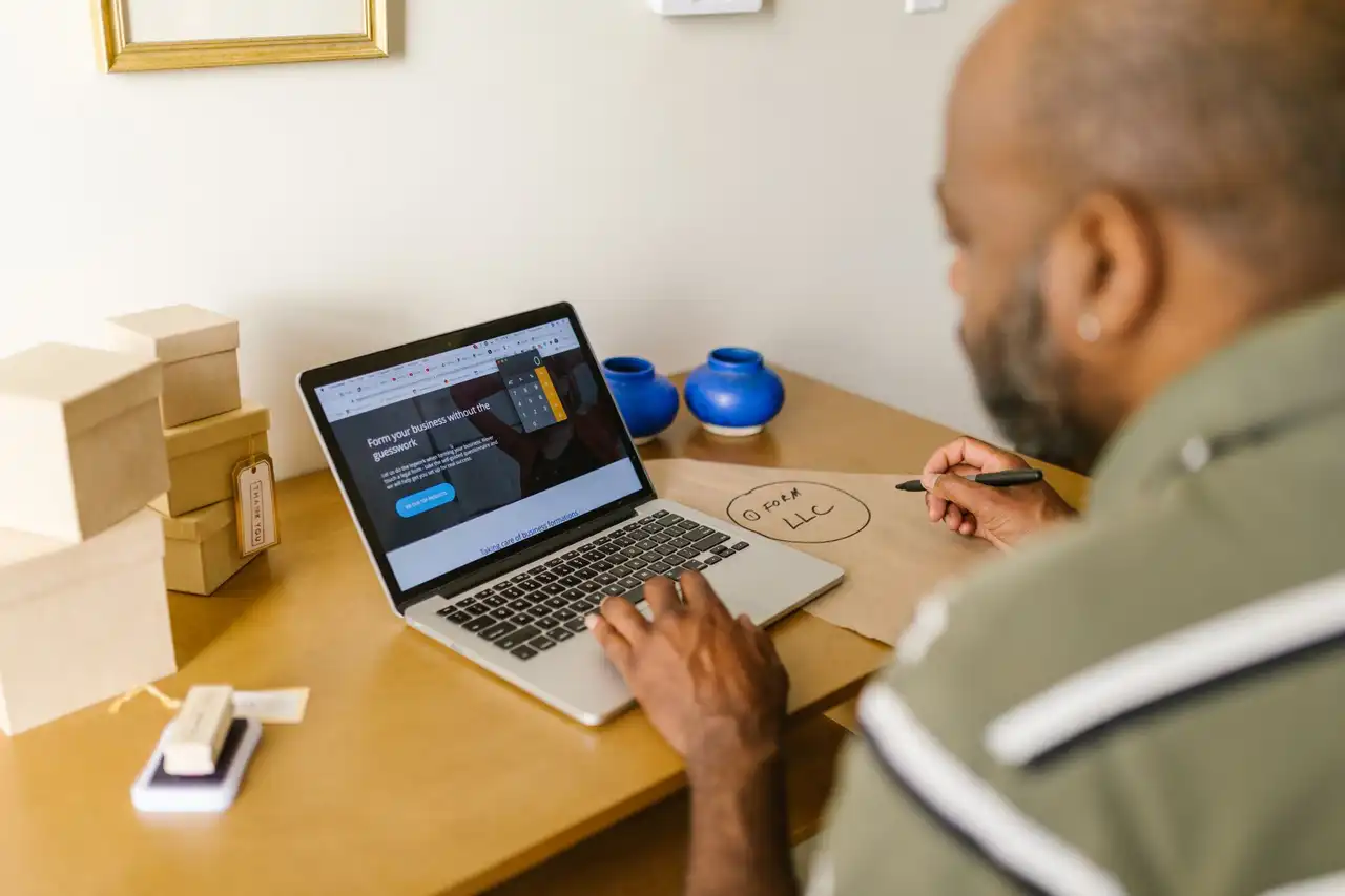 A business owner reviewing his website on a laptop